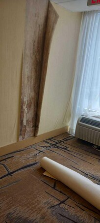 Wallpaper peeling off the hallway outside room