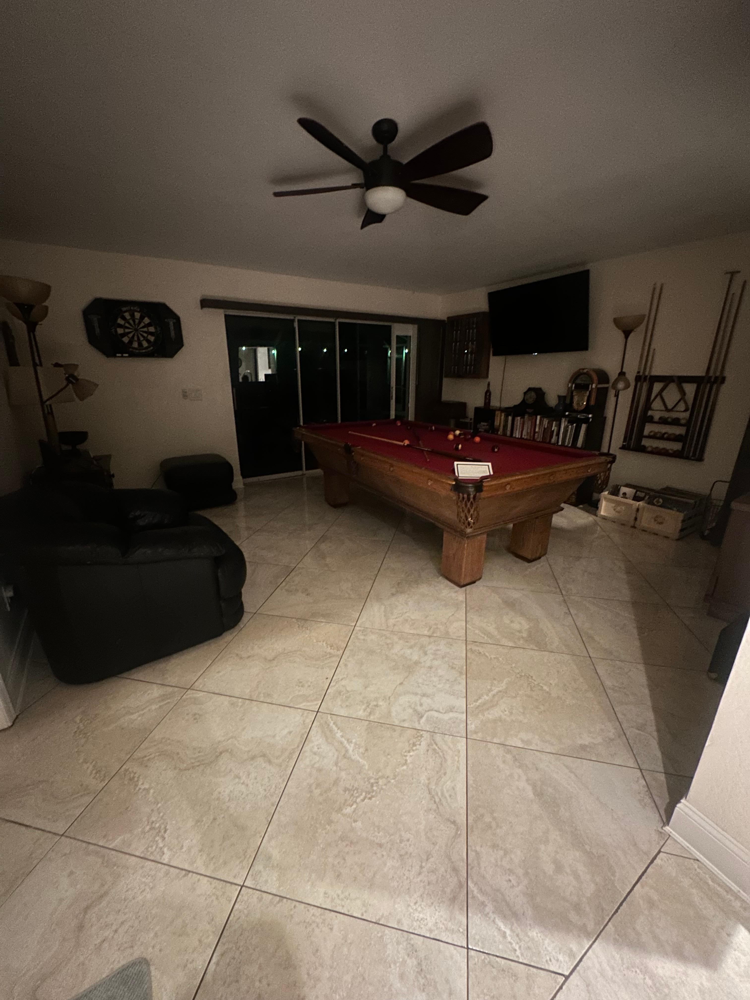 The area with the pool table just behind the kitchen.