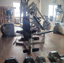 Closed gym has construction materials near mirror