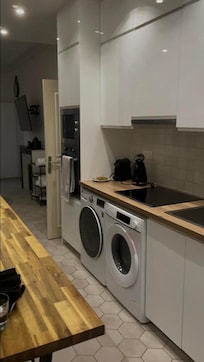 Kitchen area with washer/dryer/stove.
