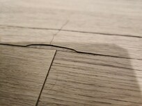 Laminate floor had sharp and lifted areas with the potential to cut our feet in multiple areas of the hotel room.