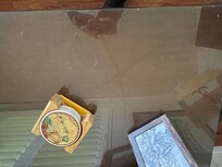 Glas table in the living room covered with dust