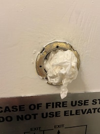 Tissue stuffed broken peep hole.