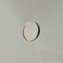 One of the holes in the shower door where the door handle/towel holder should be.