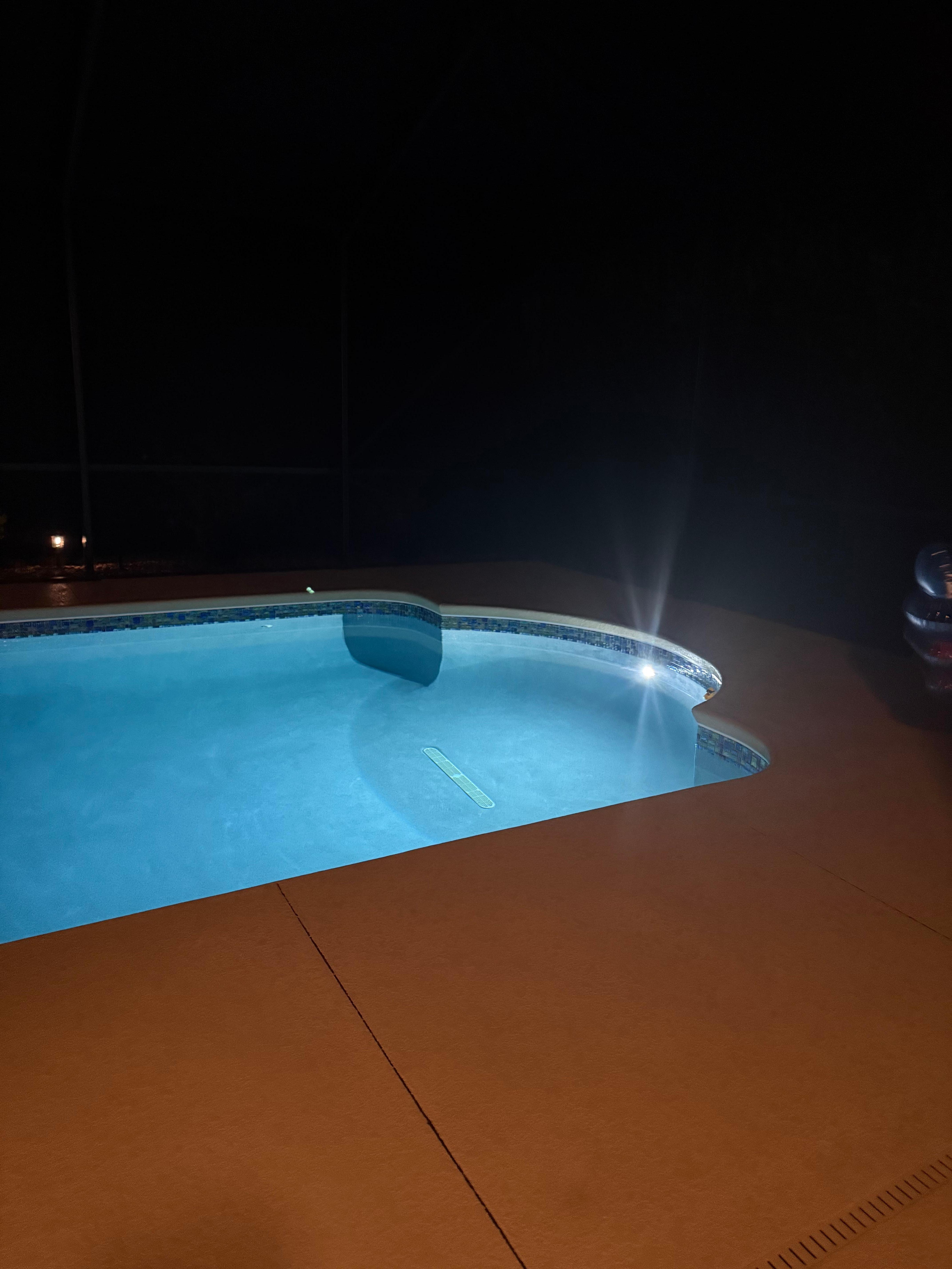 Pool with the lights on at nighttime - peaceful 