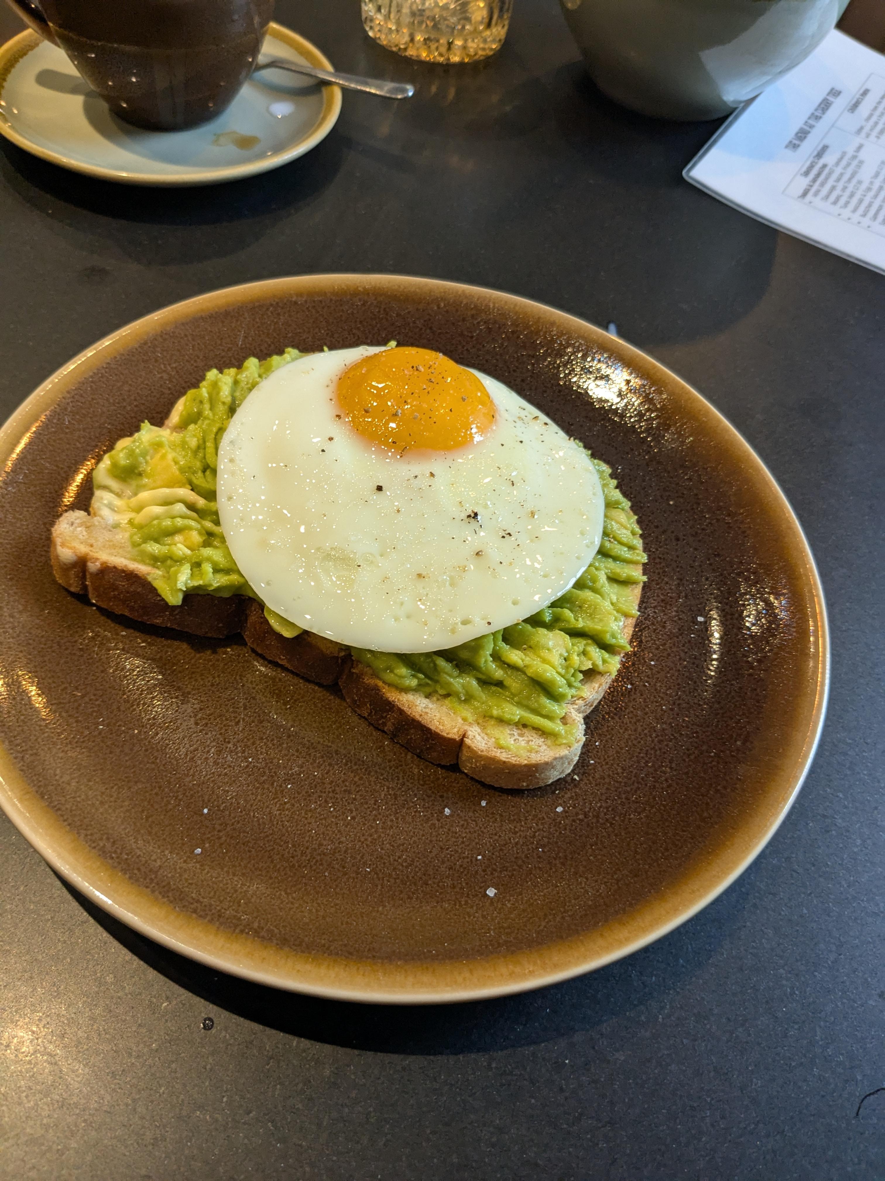 Unusual fried egg on my crushed avocado. 