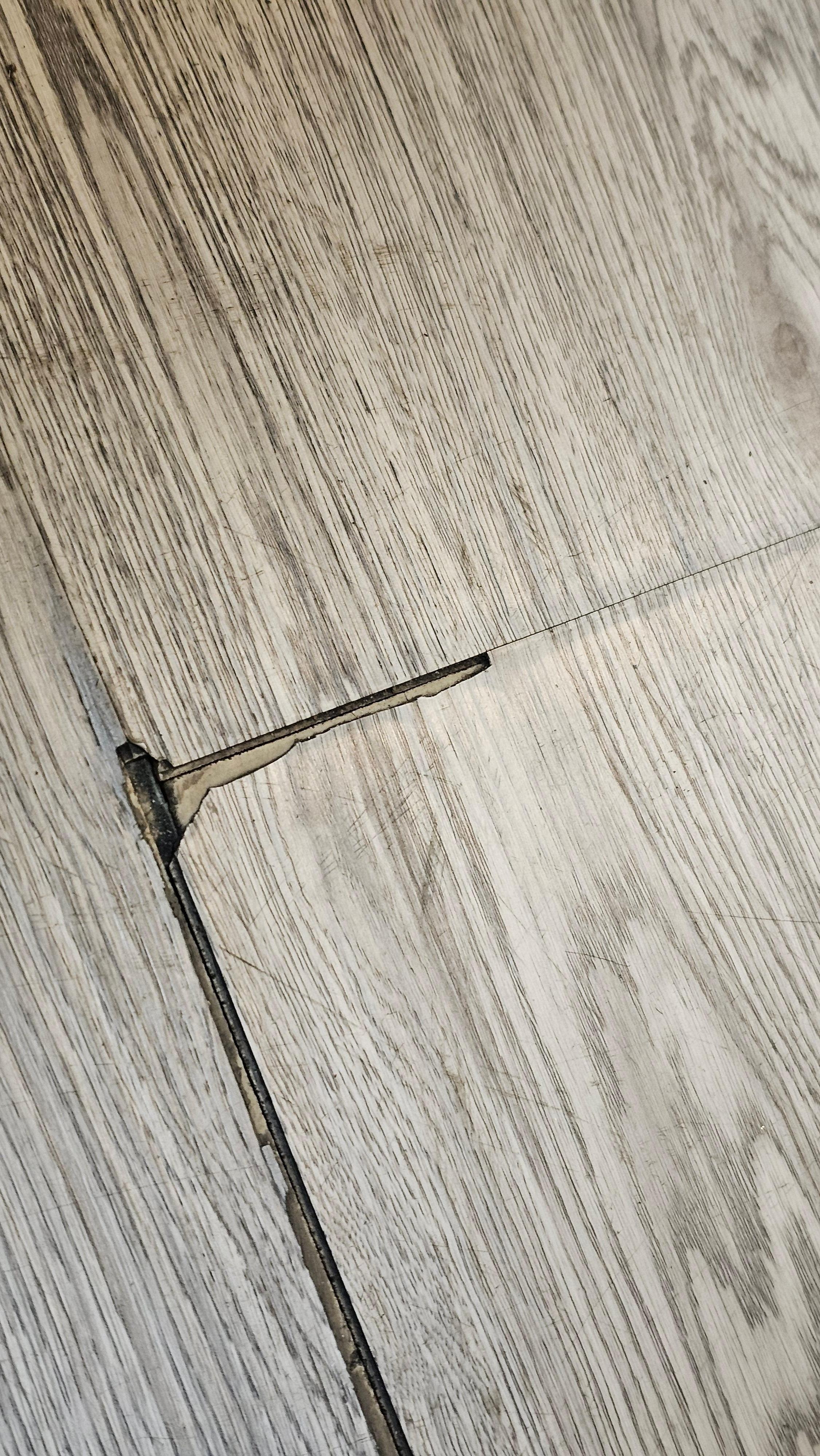 Room vinyl floor coming up all over the room.  Trip hazard & caused black dust all over floor.