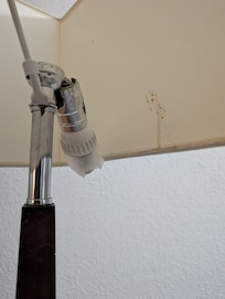 Broken light bulb pieces on the ground too