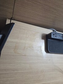 Something brown and sticky all over this table, the phone was stuck to it.