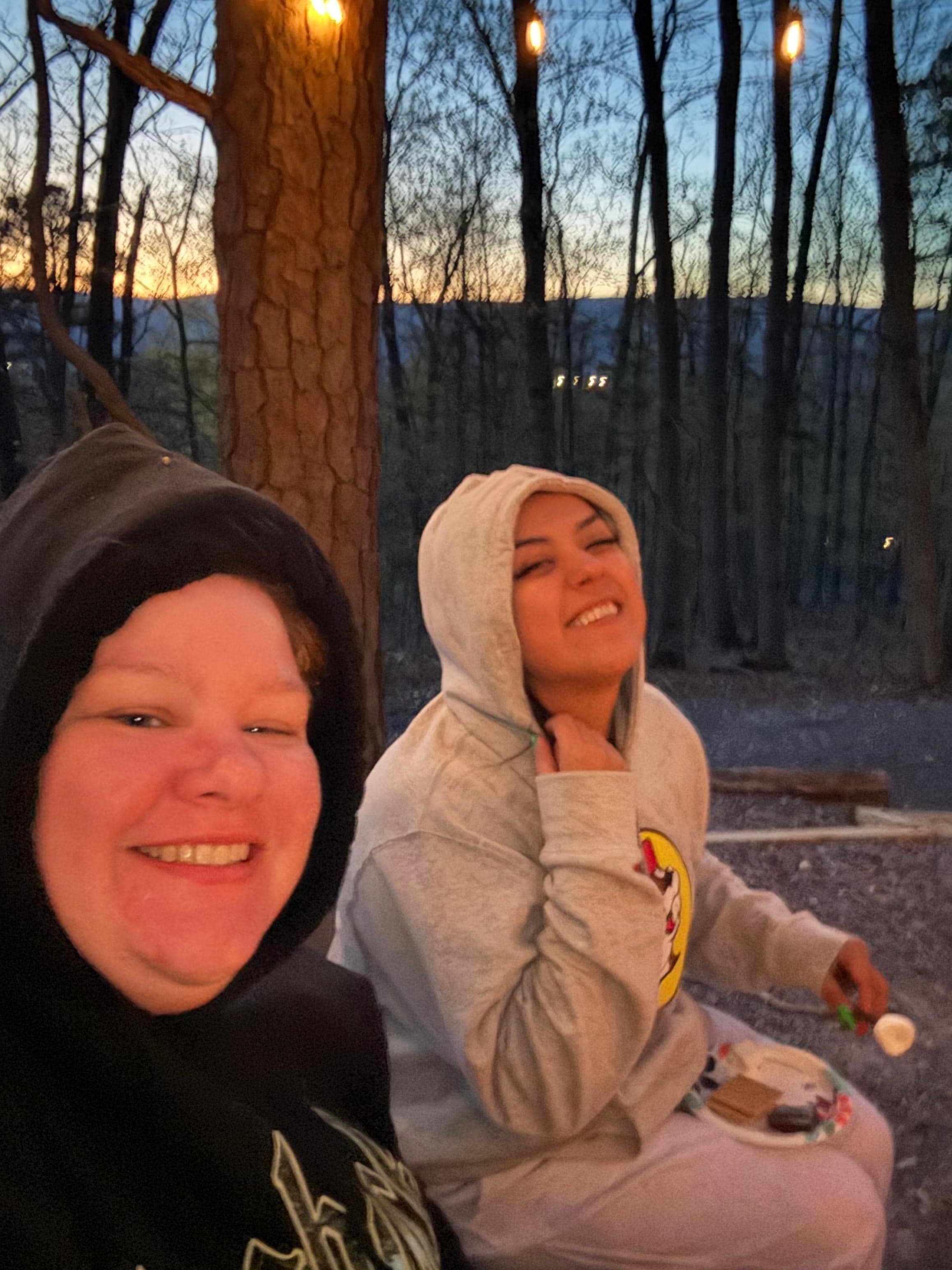 Staying warm around the fire in the cold.