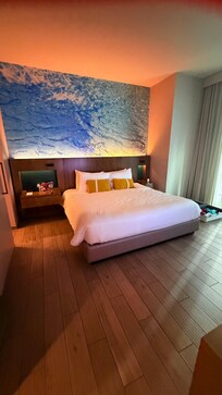 Bedroom with lovely lighting and an accent wall