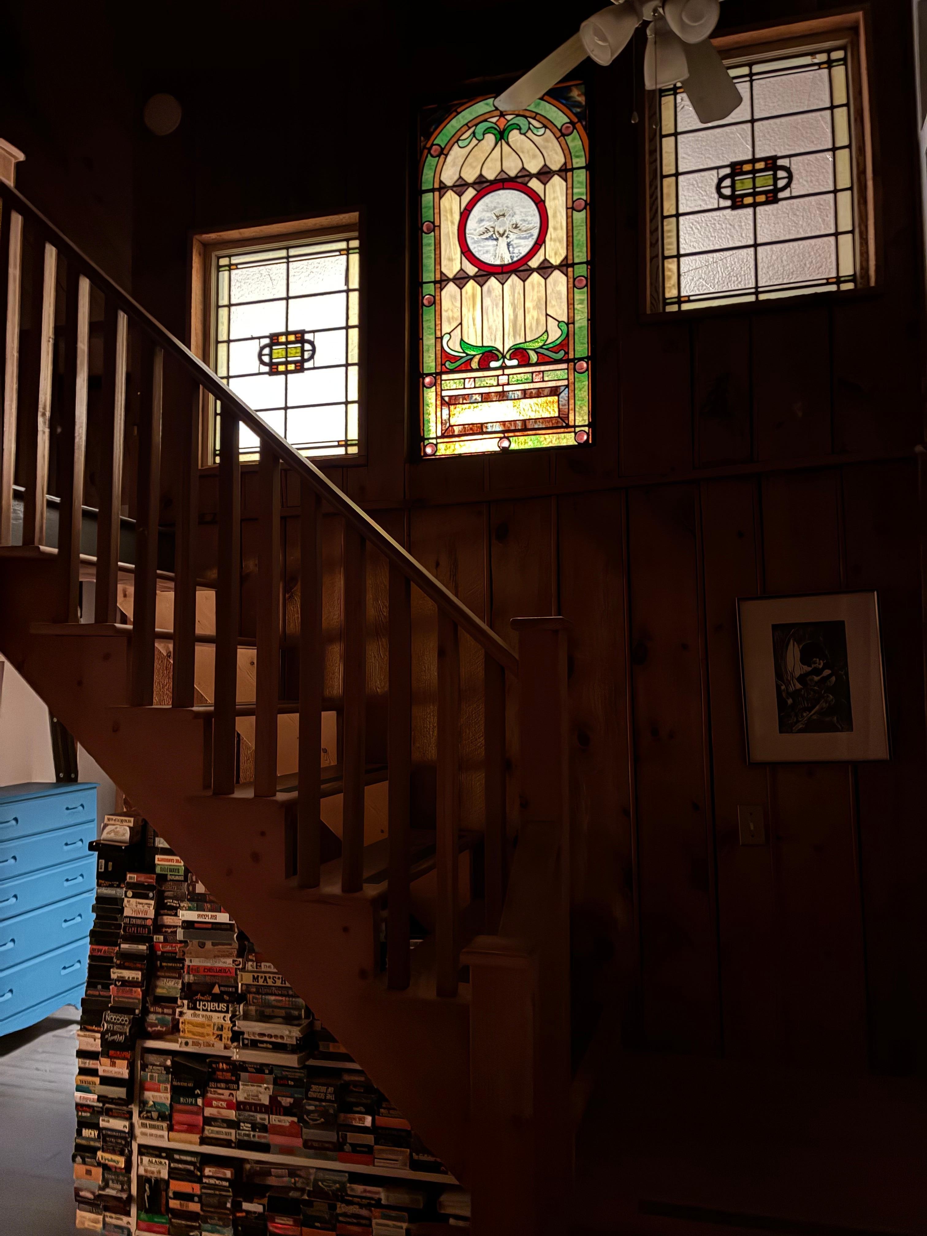 Beautiful stained glass windows. You can also see some of the VHS collection below the stairs.