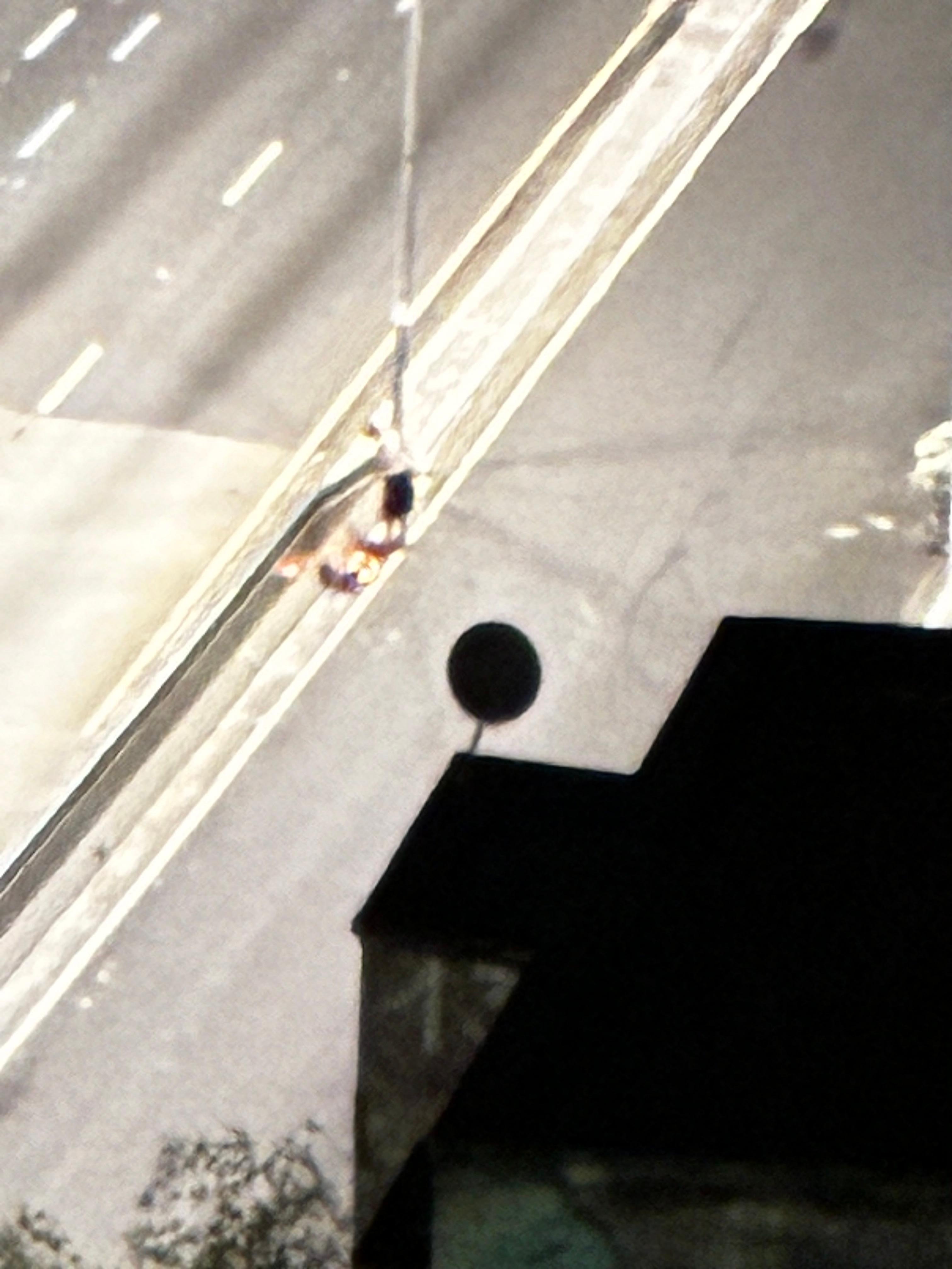 Homeless crackhead starting a street fire outside hotel. Taken from room window.