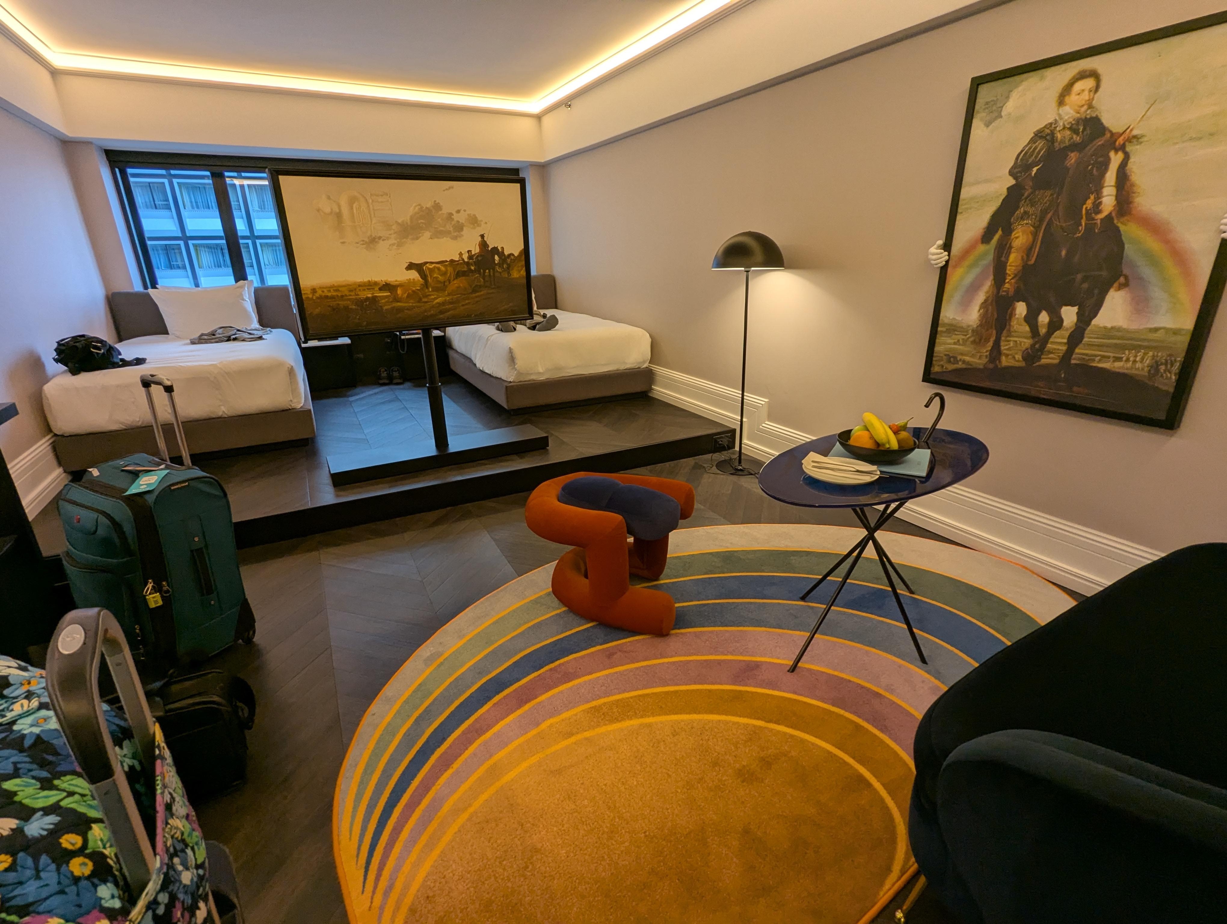 Two ditict sections to the room, separated by a step and a large TV that can be rotated to either side 