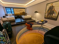 Two ditict sections to the room, separated by a step and a large TV that can be rotated to either side