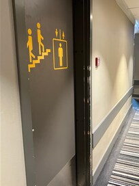 Door w scratches and abrasions leading to elevator and stairs