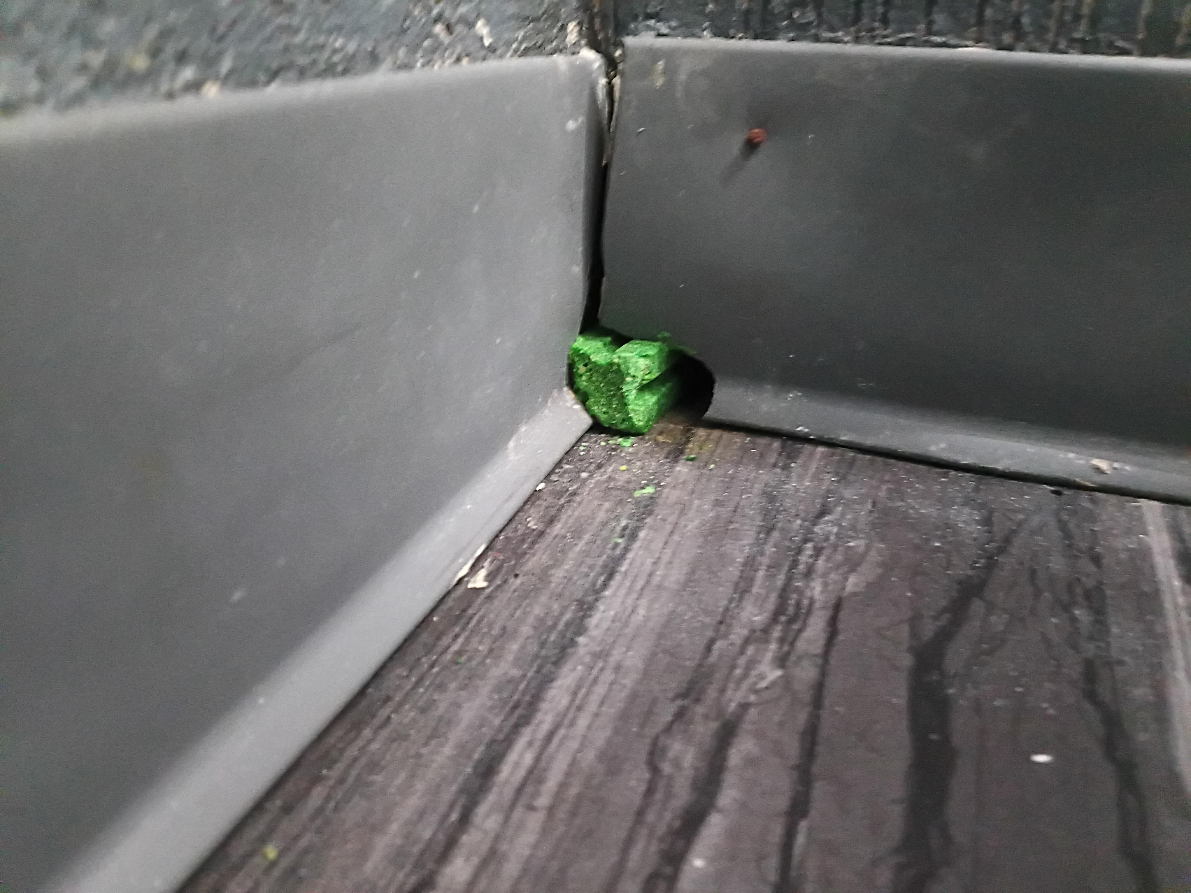 Hole in wall with rat bait 