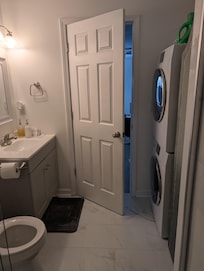 Bathroom with low curb shower, washer and dryer