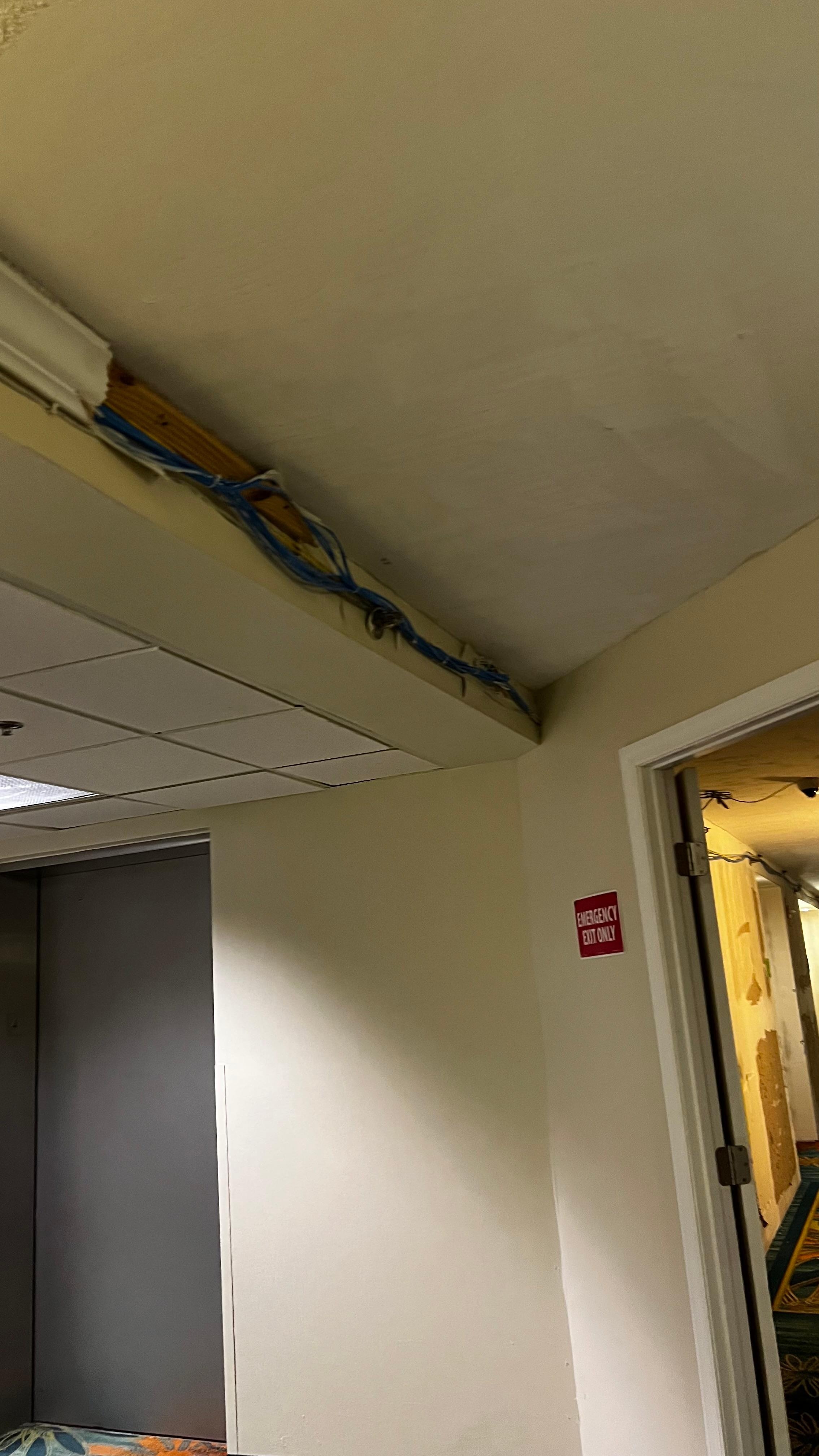 Uncovered wires in the hallway 