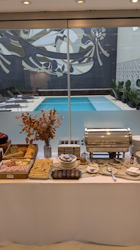 Part of the breakfast buffet with pool in background