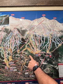 Pointing to where house is in proximity to ski and town