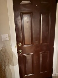 Badly pray-painted front door. Eewww.