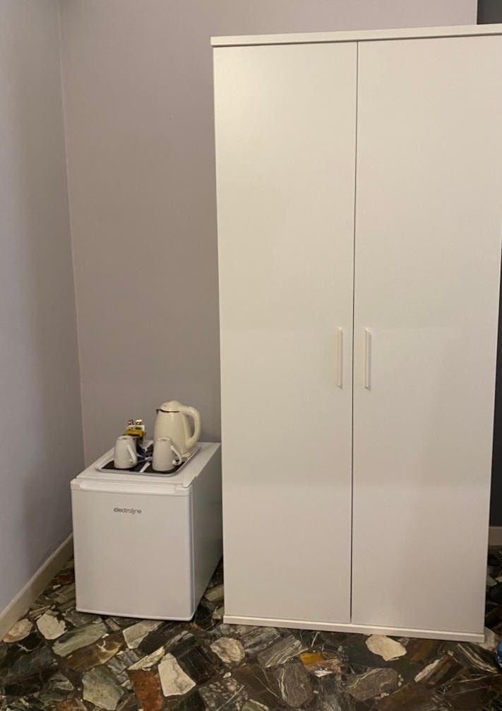 Room 102 had a mini-fridge and a wardrobe with extra blankets, hangers, a safe.