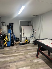 Storage of window screens, vacuums, mops, pictures, etc. in one of the bedrooms