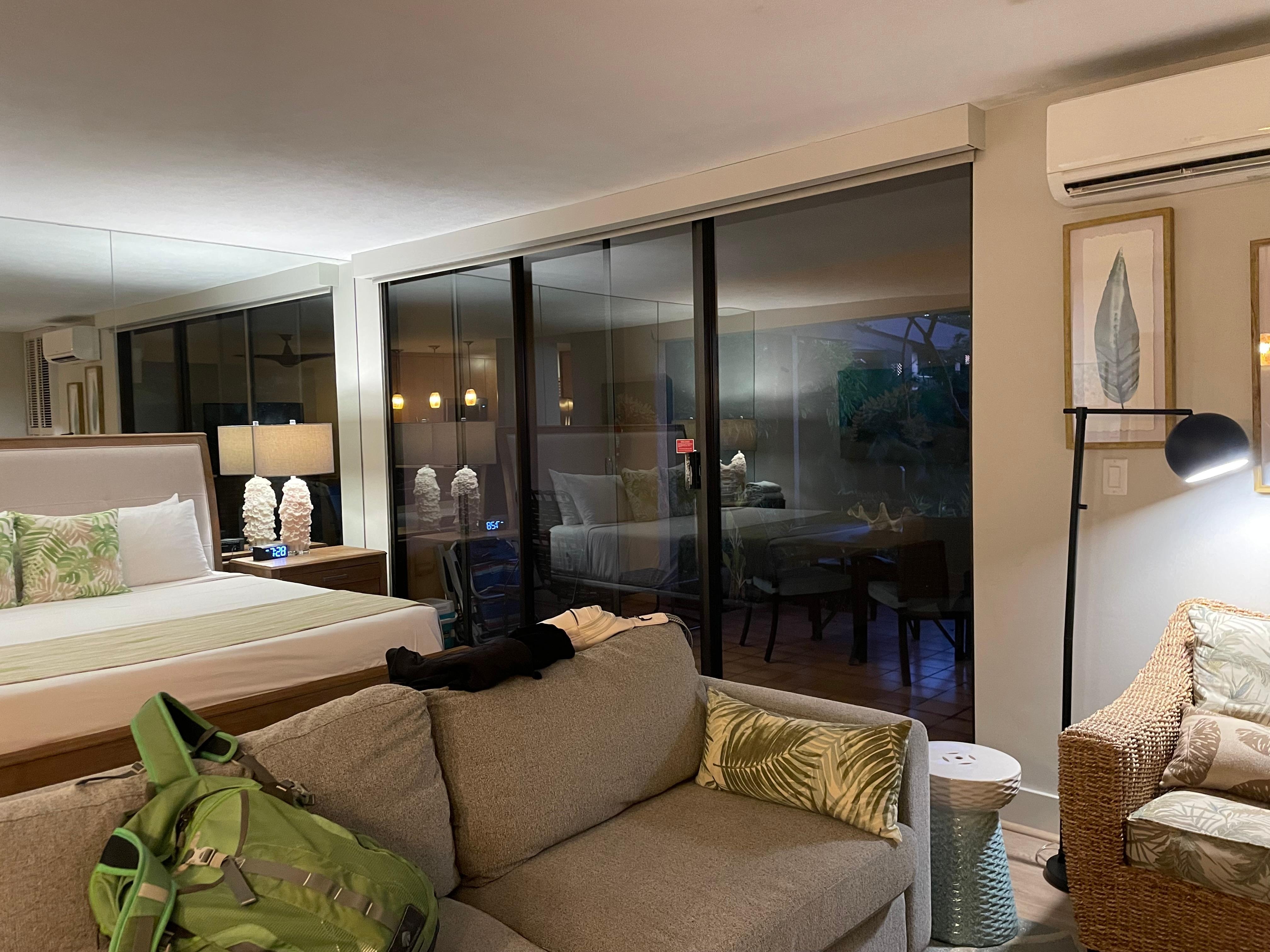 Sitting area and bed with wall to floor windows