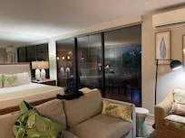 Sitting area and bed with wall to floor windows