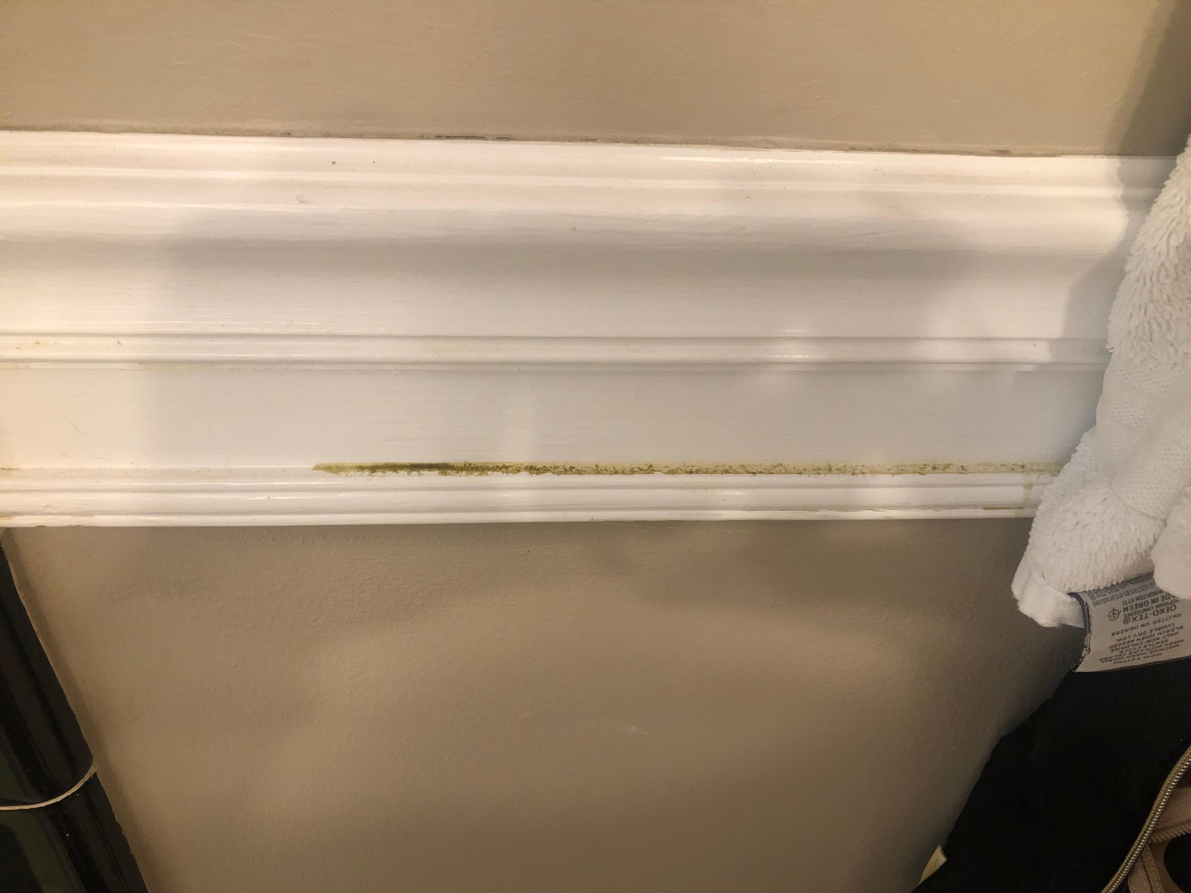 Located behind towel on towel rack in bathroom