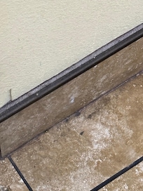 what appears to be mold in the bathroom section outside of the door by the sink area
