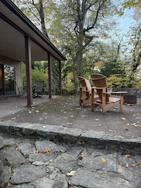 The patio is massive and beautiful. It has a dining table under the overhang and comfortable Adirondack chairs with a fire pit overlooking the back. A perfect place to relax!!!!!