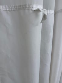 Unclean, dingy and stained shower curtain needs to be replaced.