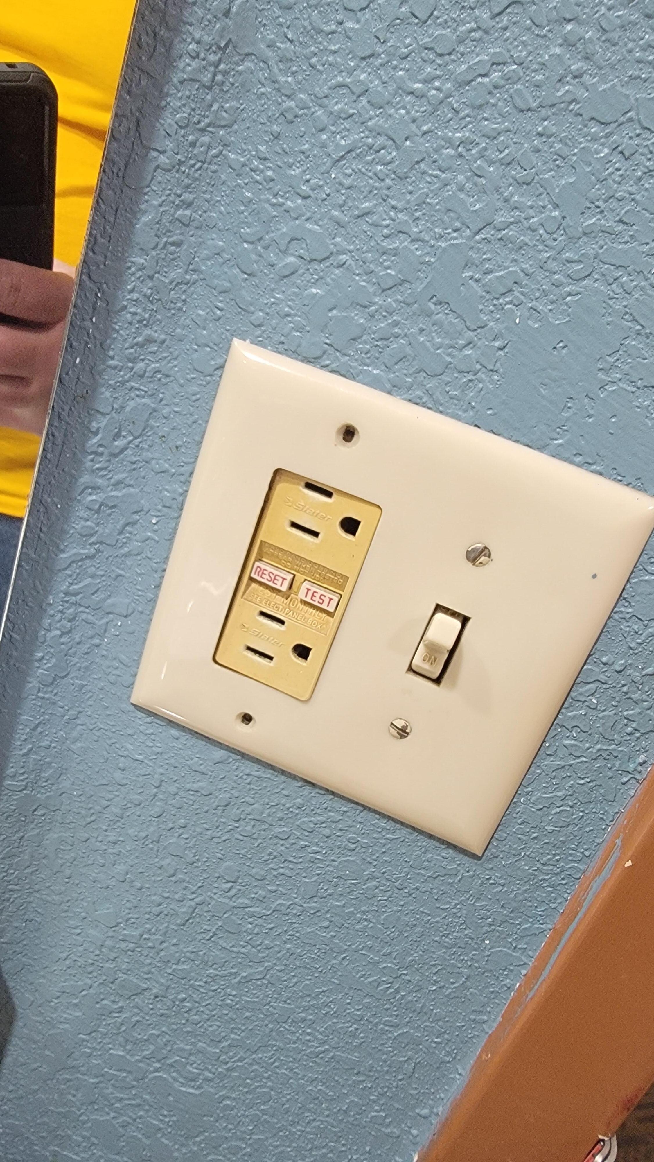 Deeply discolored outlet in bathroom
