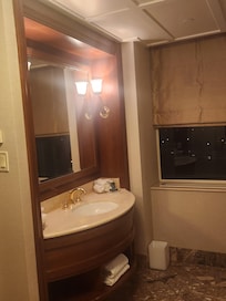 Sink area. Would have like to have see a higher quality window shade, but it worked well. Just didn't match the quality scale of the room.
