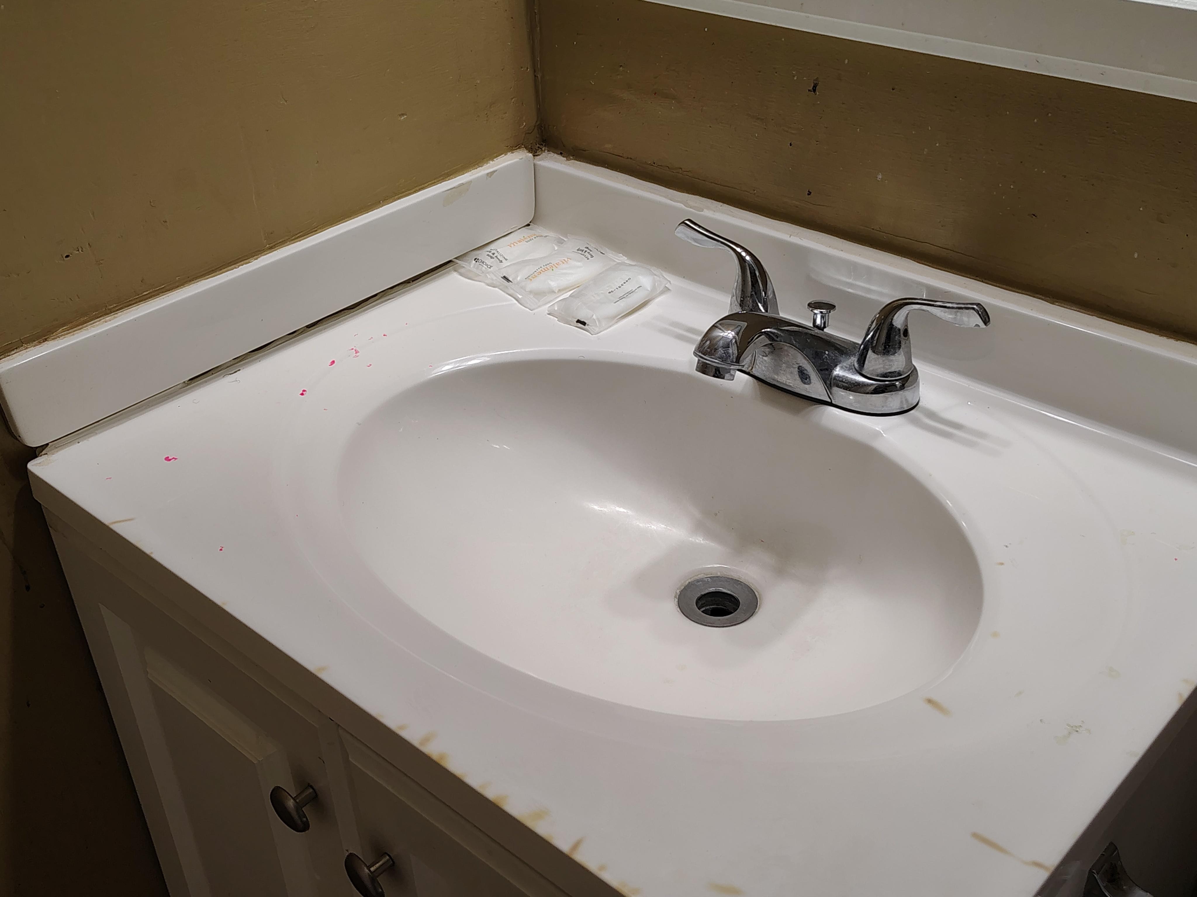 Burn marks from cigarettes on the edge of the sink