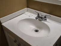 Burn marks from cigarettes on the edge of the sink