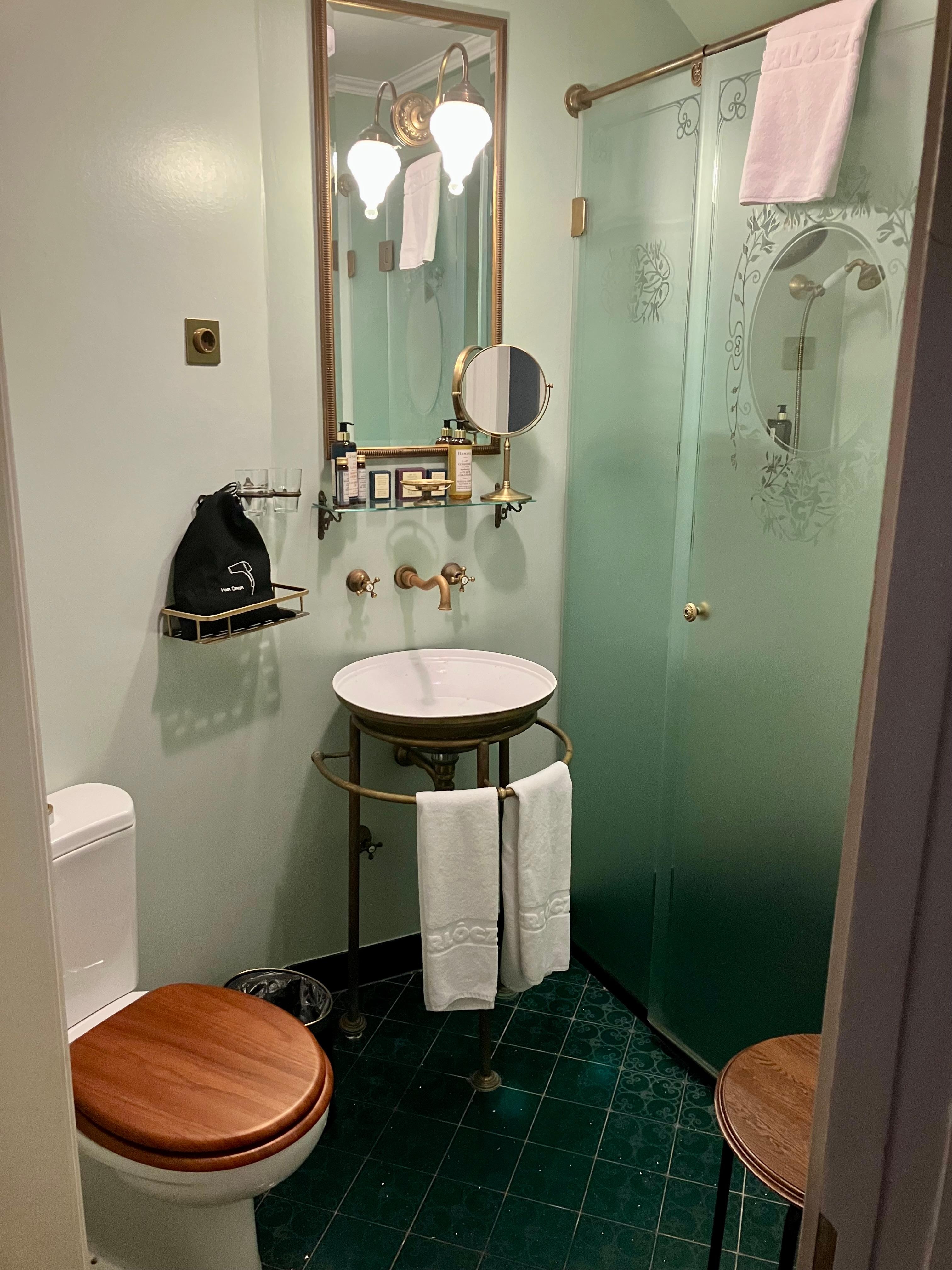 Green-tiled bathroom with heated floor