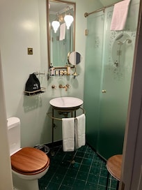 Green-tiled bathroom with heated floor