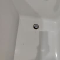 Small pieces of matter and hair and a dysfunctional drain plug.