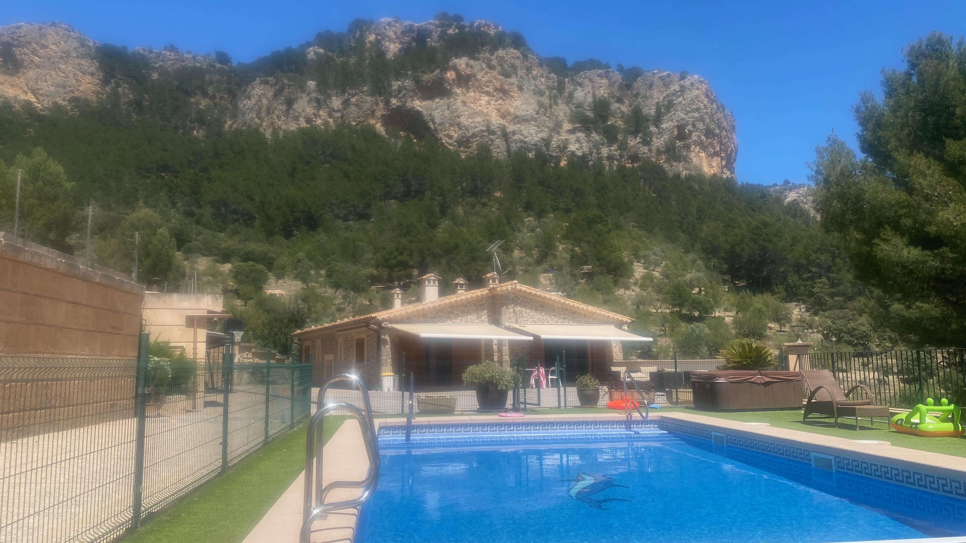 From shaded cabana, across pool towards house.