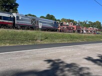 View of passing train from walking trail by the river