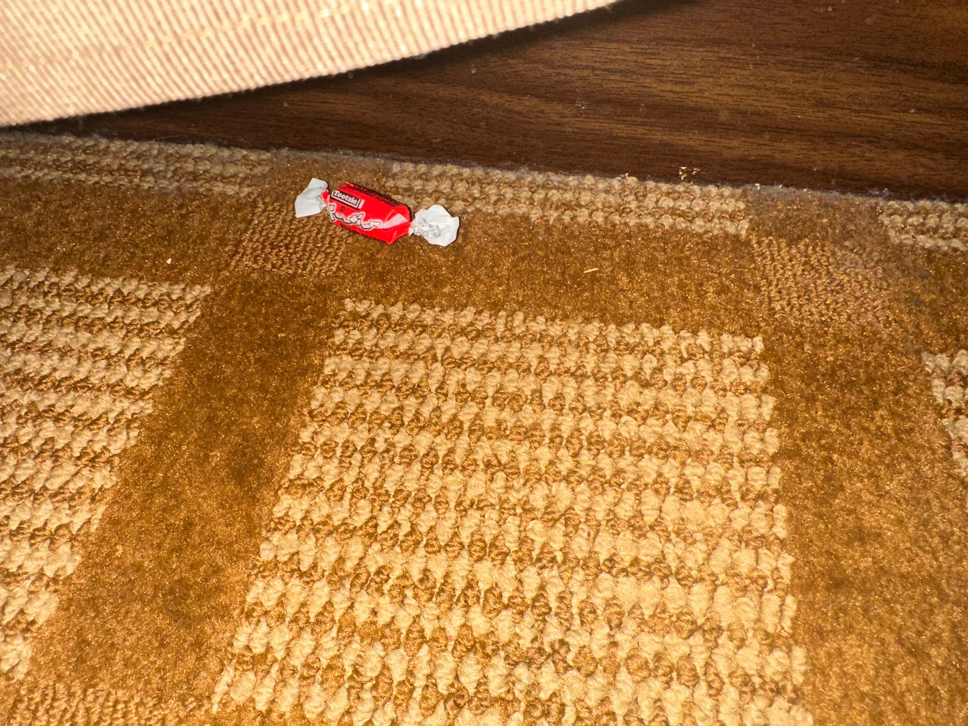 Candy on floor under other bed. 