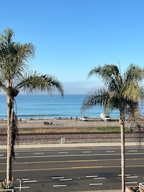 View from balcony. Great chairs to sit and watch waves from.