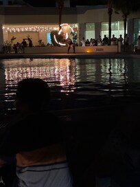 Fire juggling show by the pool outside