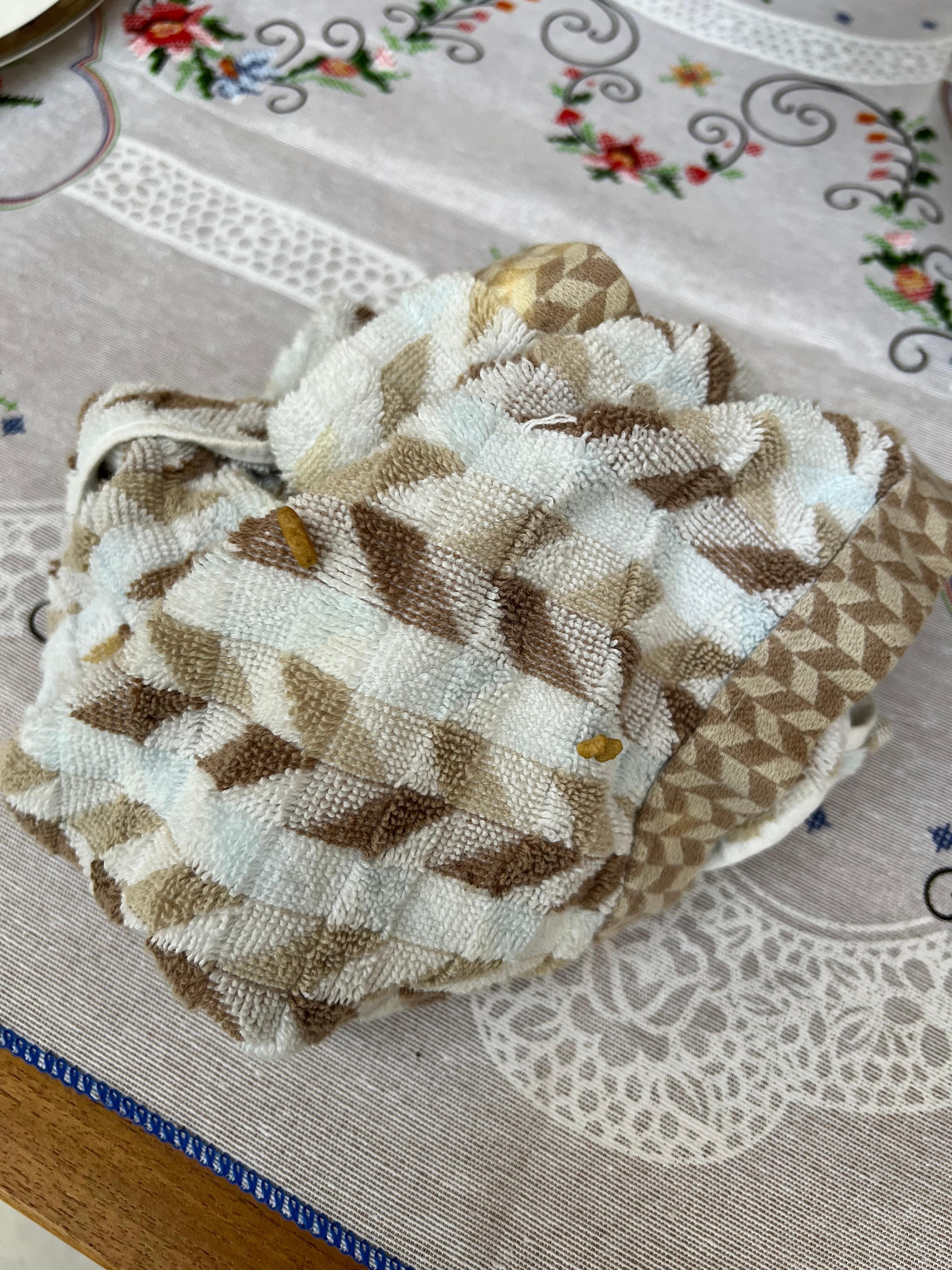 Kitchen towel pulled from drawer and used before realizing there were food debris stuck to it.