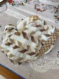 Kitchen towel pulled from drawer and used before realizing there were food debris stuck to it.