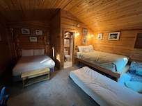 Family cabin. 2 Queen beds with twin trundle under one of them.