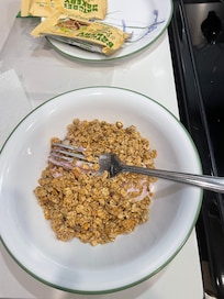 Eating yogurt and cereal with a fork because we had no spoon